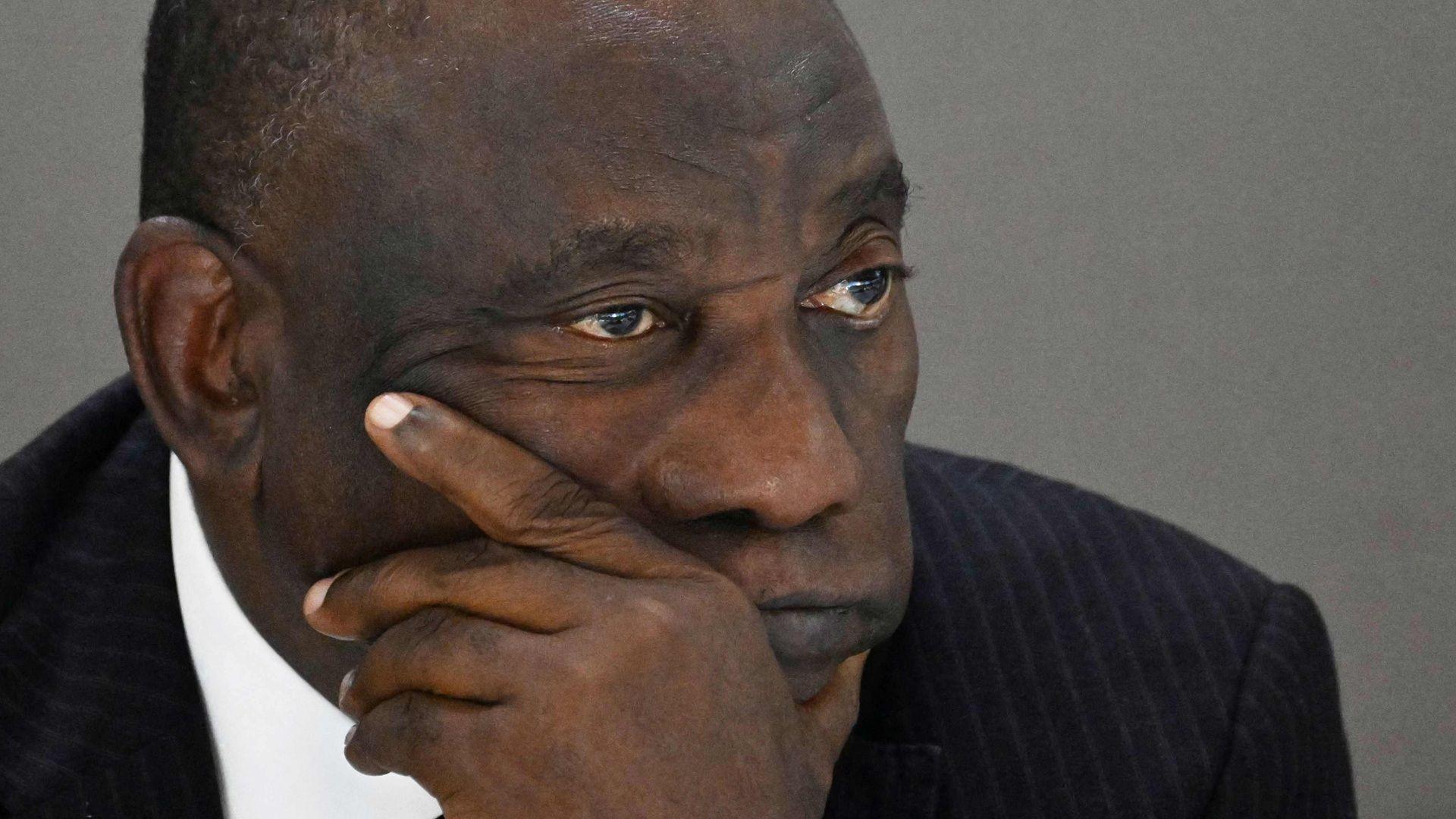 A photo of Cyril Ramaphosa looking pensive or dejected with his hand clasped to his face.