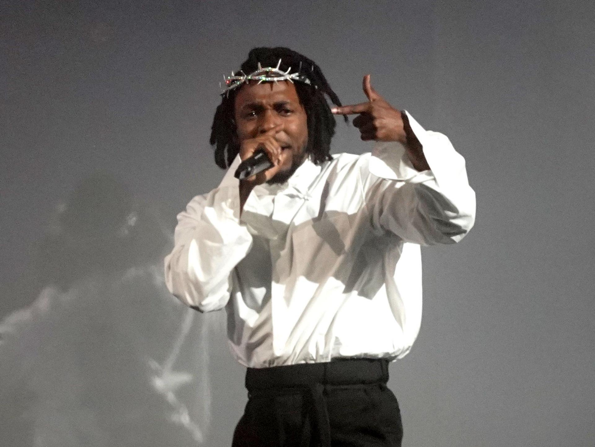 Kendrick Lamar, wearing a silver crown of thorns, performs at the Glastonbury Festival