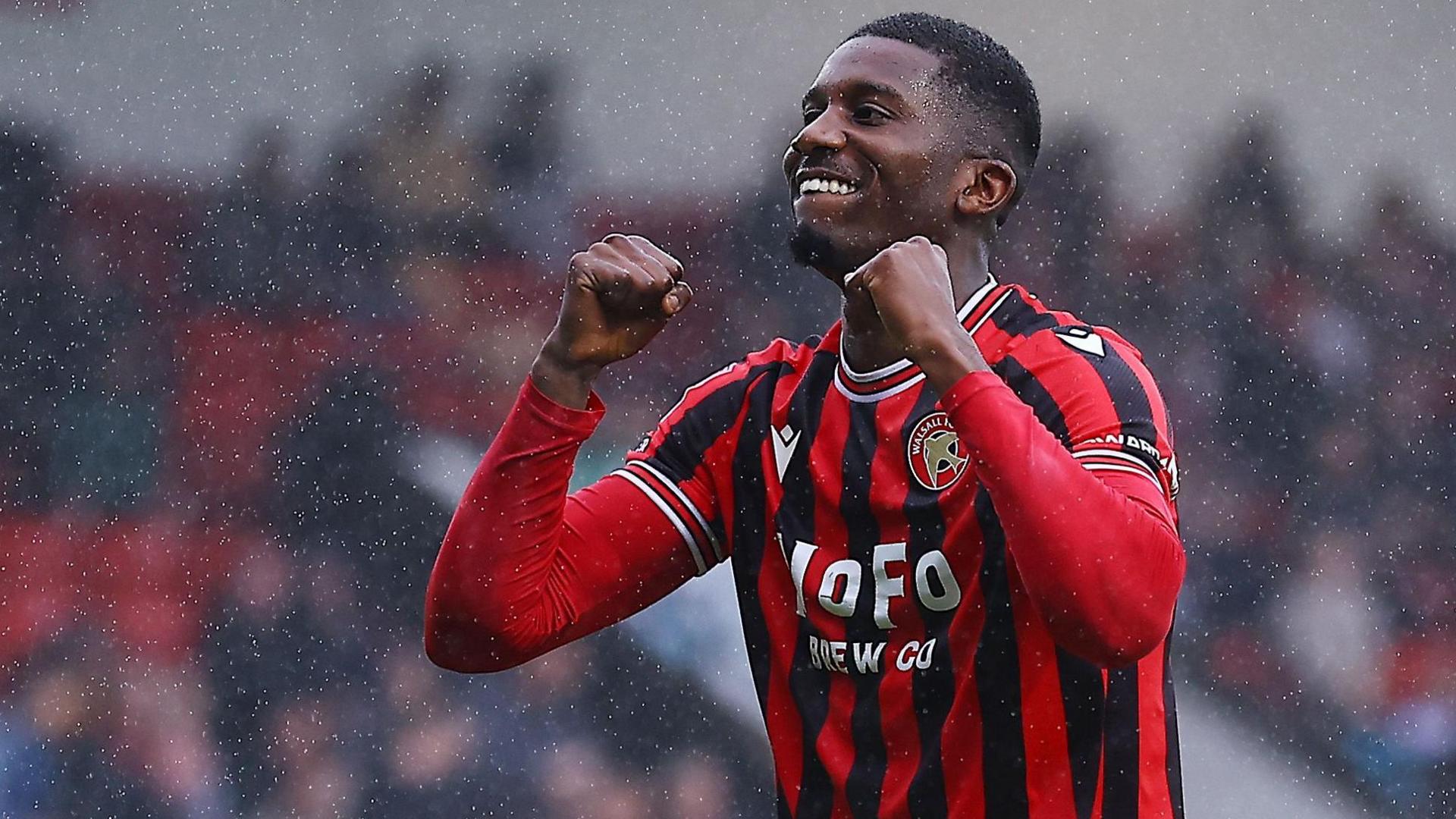 Daniel Kanu pumps both fists in celebration at scoring a goal