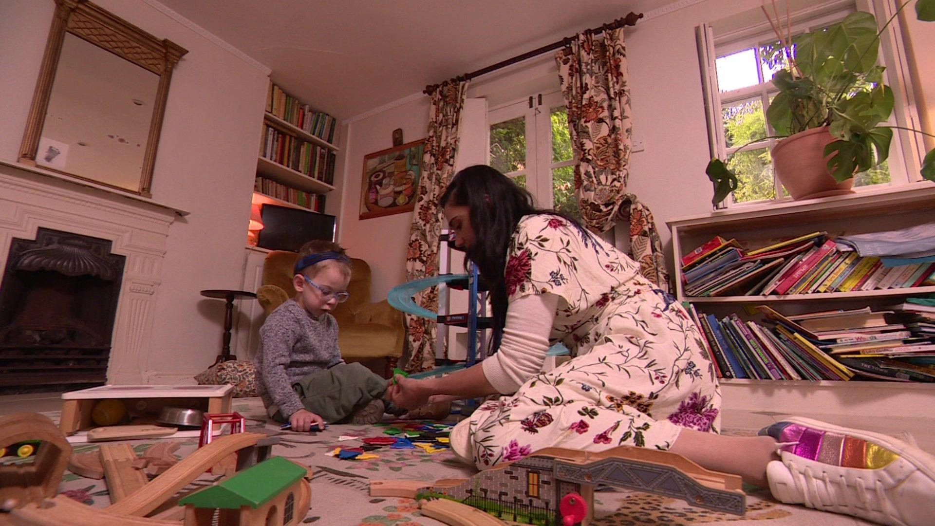 Sian plays with son Ali in their living room