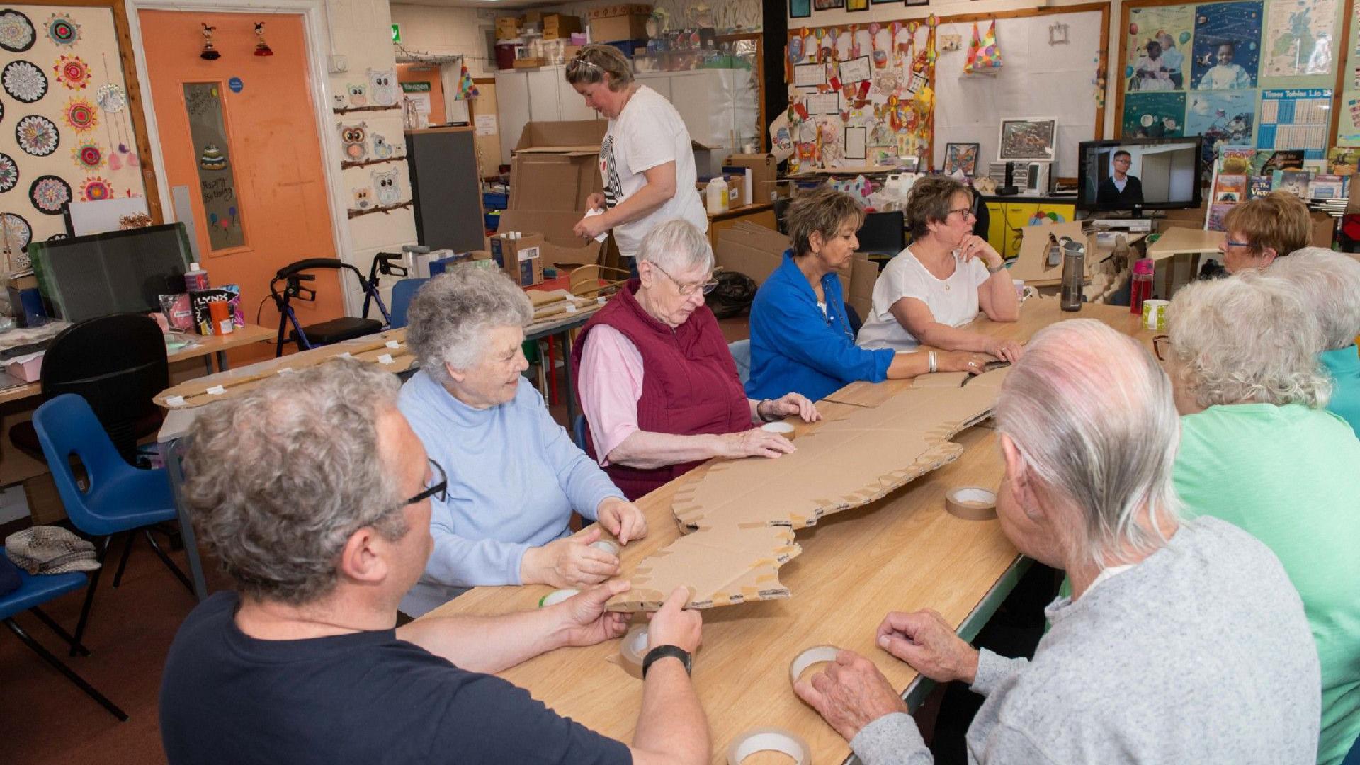 A community group building cardboard soldiers for the sculpture. at Falsgrave Community Centre 