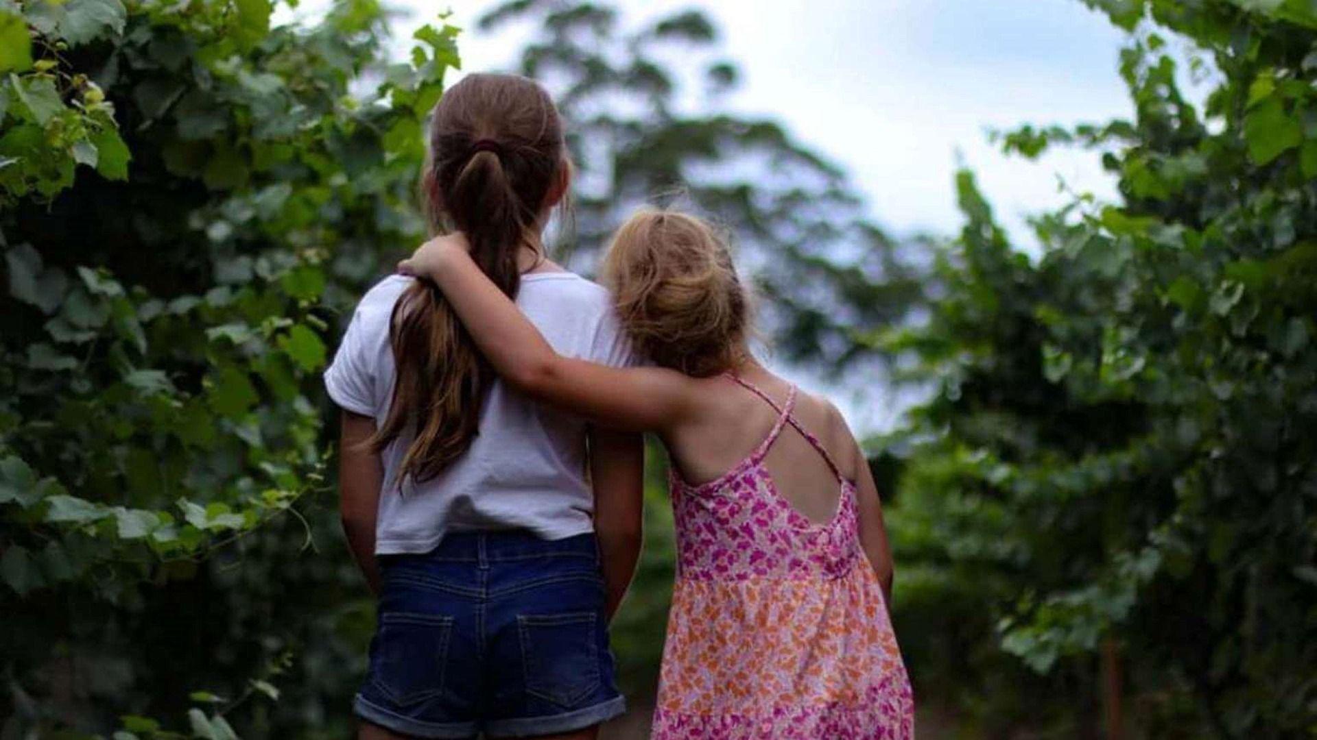 Two girls looking at trees