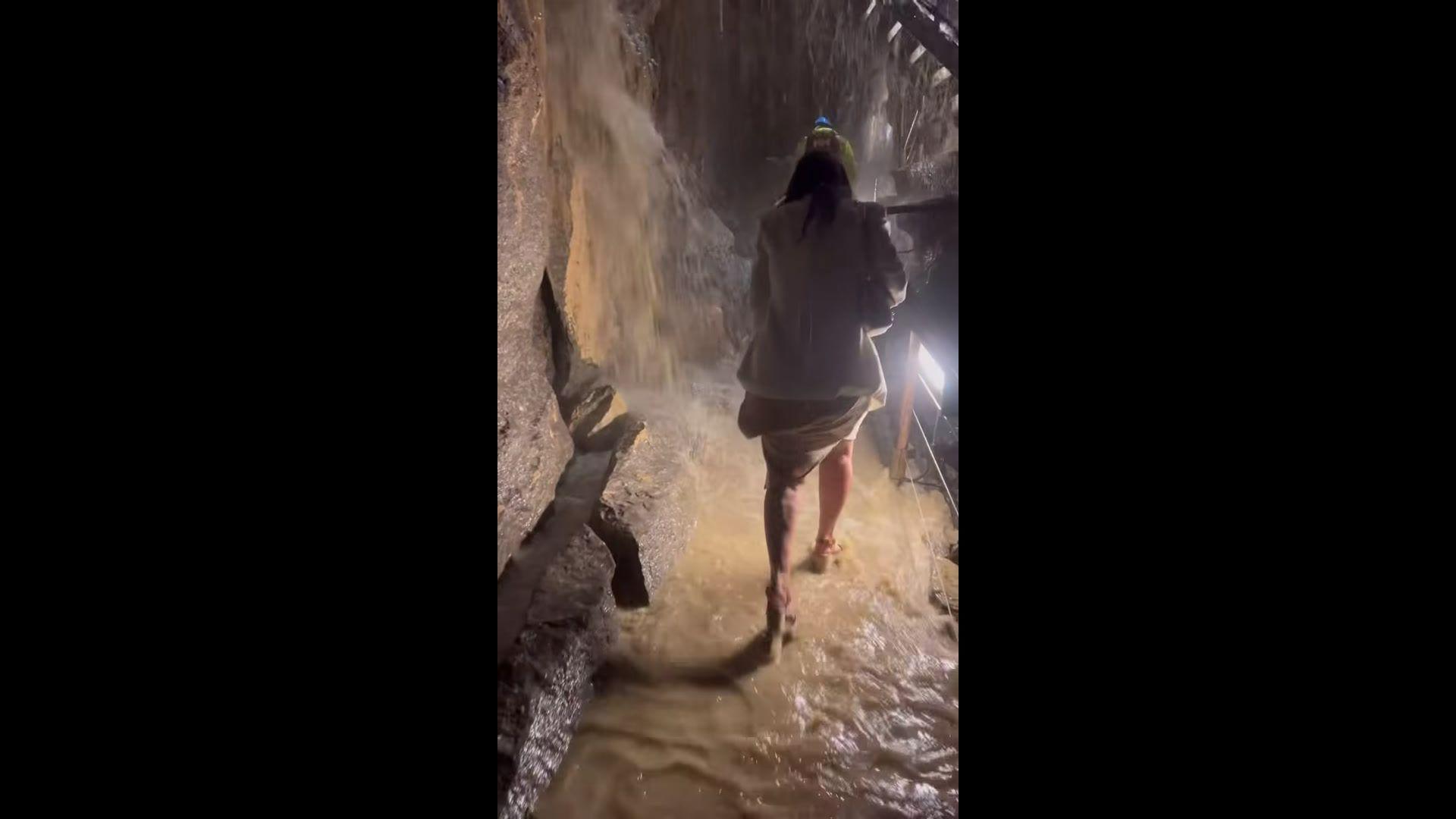 Kim Mahon Hay walking through Marble Arch Caves fooded.