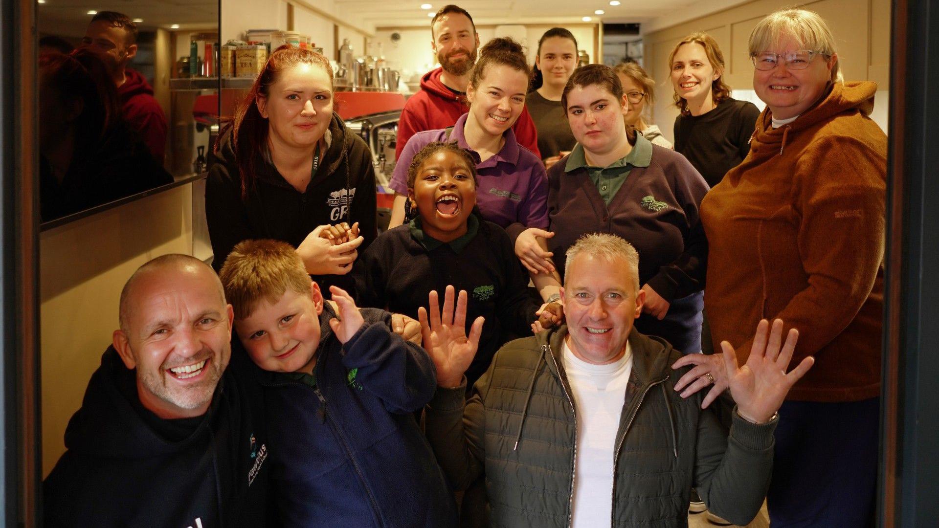 Teachers and pupils pose for the camera on the carriage