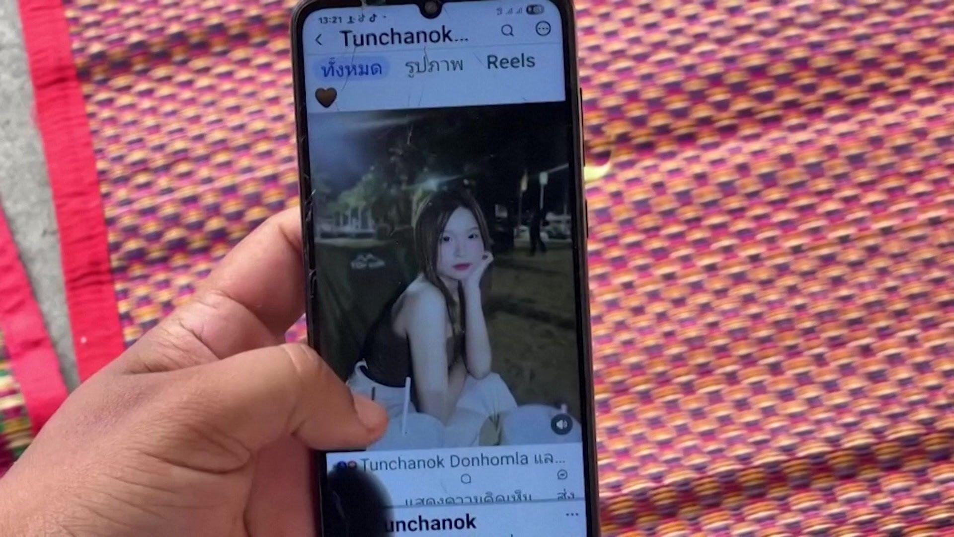 A close-up shot of a mobile phone on which an Instagram account belonging to the victim shows an image of her. She is a young woman with long brown hair and is posing with her chin rested on her hand in the evening.