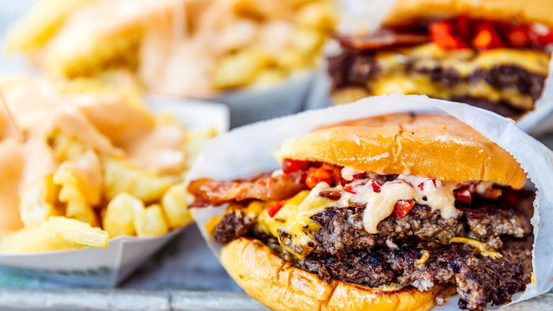 A stock image of a cheese burger and french fries