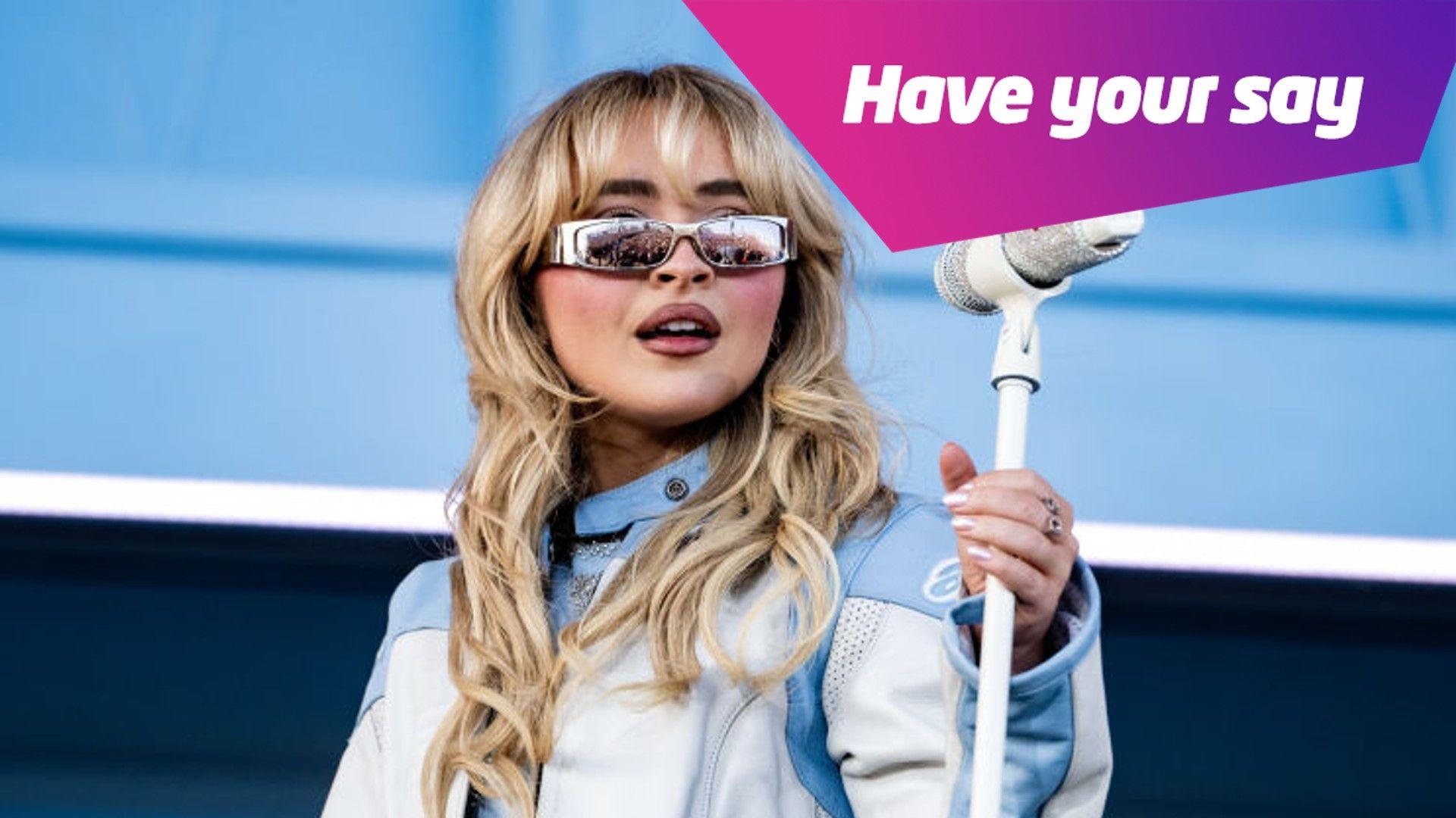 Sabrina Carpenter standing with microphone. 