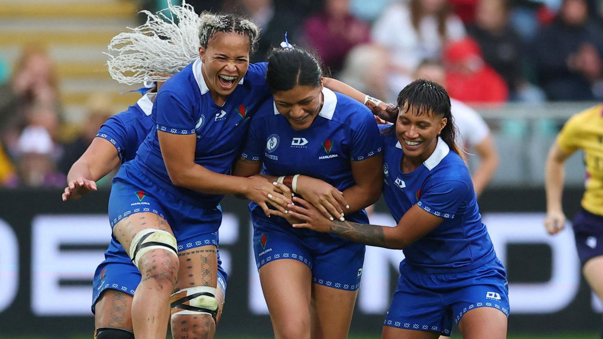 Samoa players celebrate with Harmony Vatau