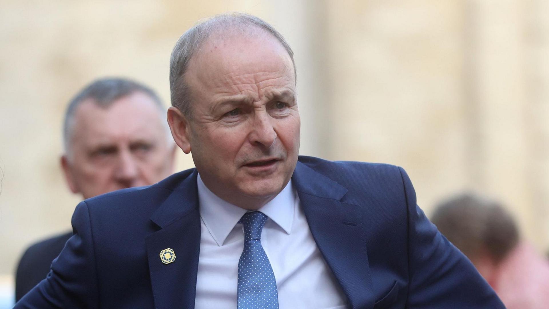 Micheál Martin at the Informal EU leaders' retreat at the Palais d'Egmont in Brussels, Belgium. He is balding, wearing a blue suit, white shirt and blue tie.