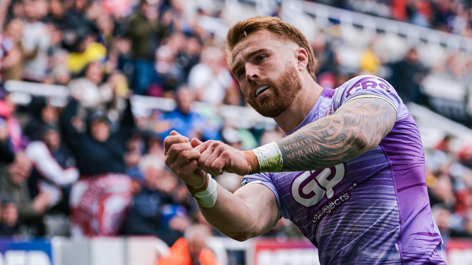 Wigan's Adam Keighran performs a golf celebration after scoring his try against Warrington at the Magic Weekend