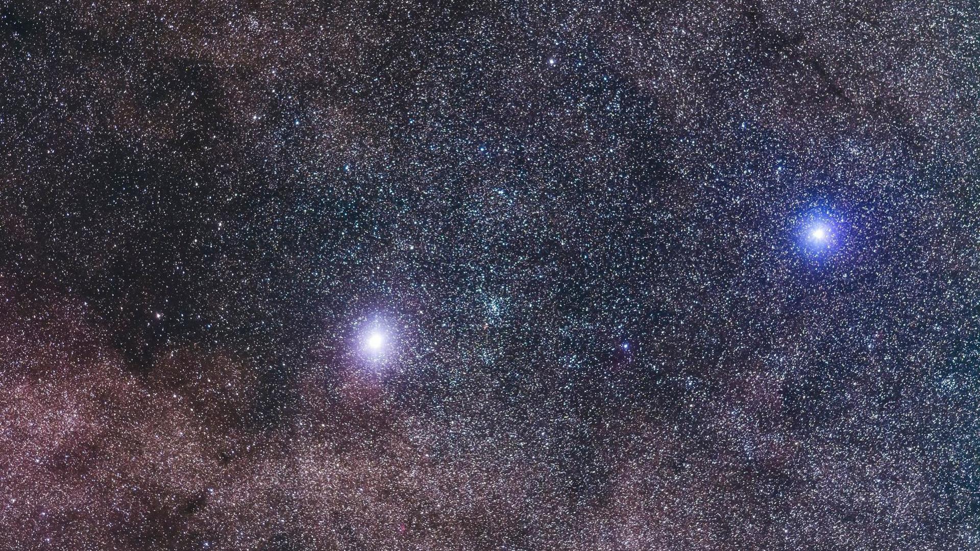 Sky seen full of stars with two of them noticeably brighter than the others