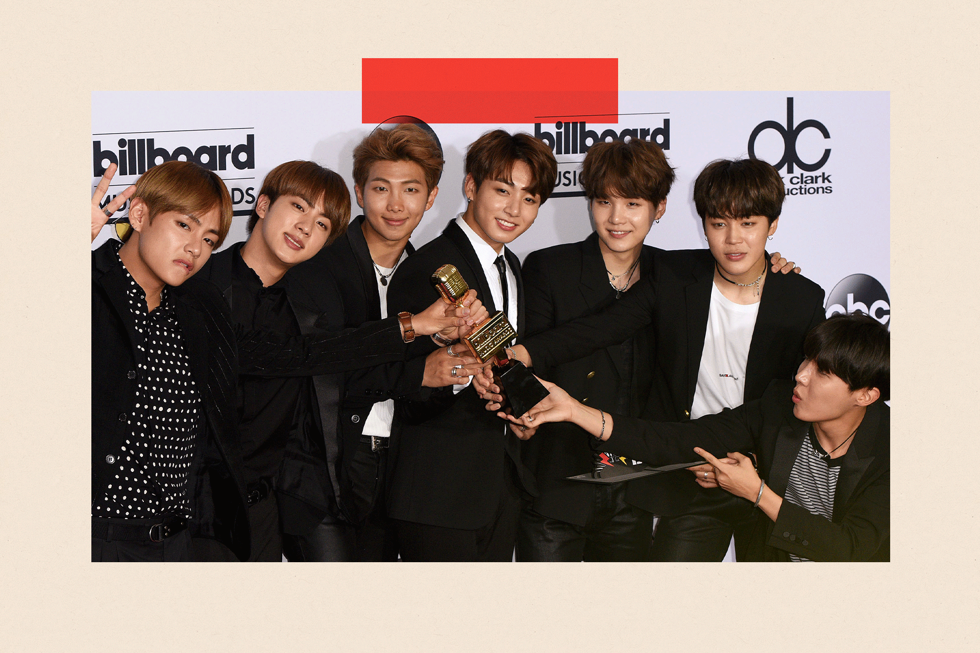 BTS pose with an award
