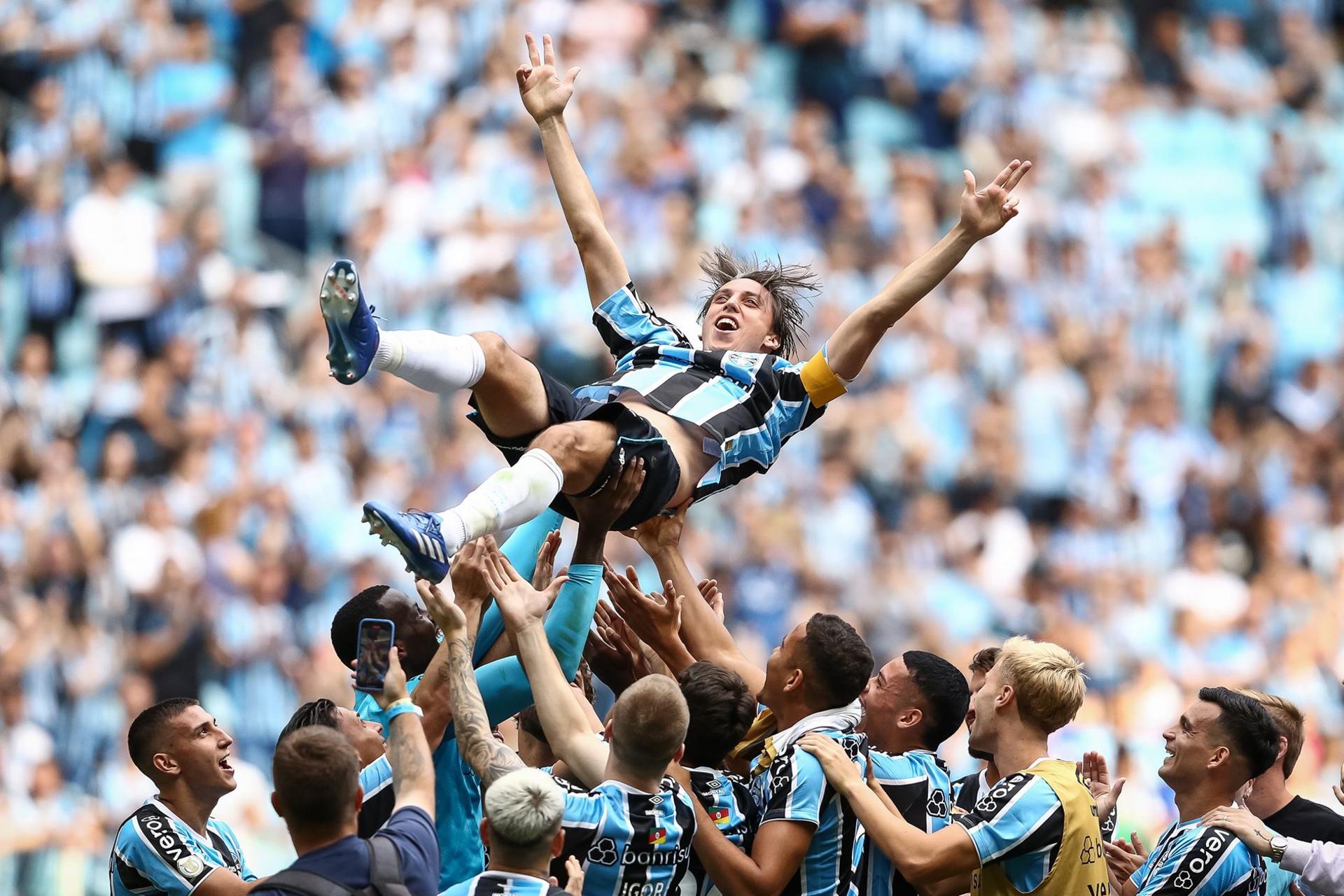 Gremio's Pedro Geromel is thrown into the air by his team-mates following the match against Corinthians - his final game before retirement