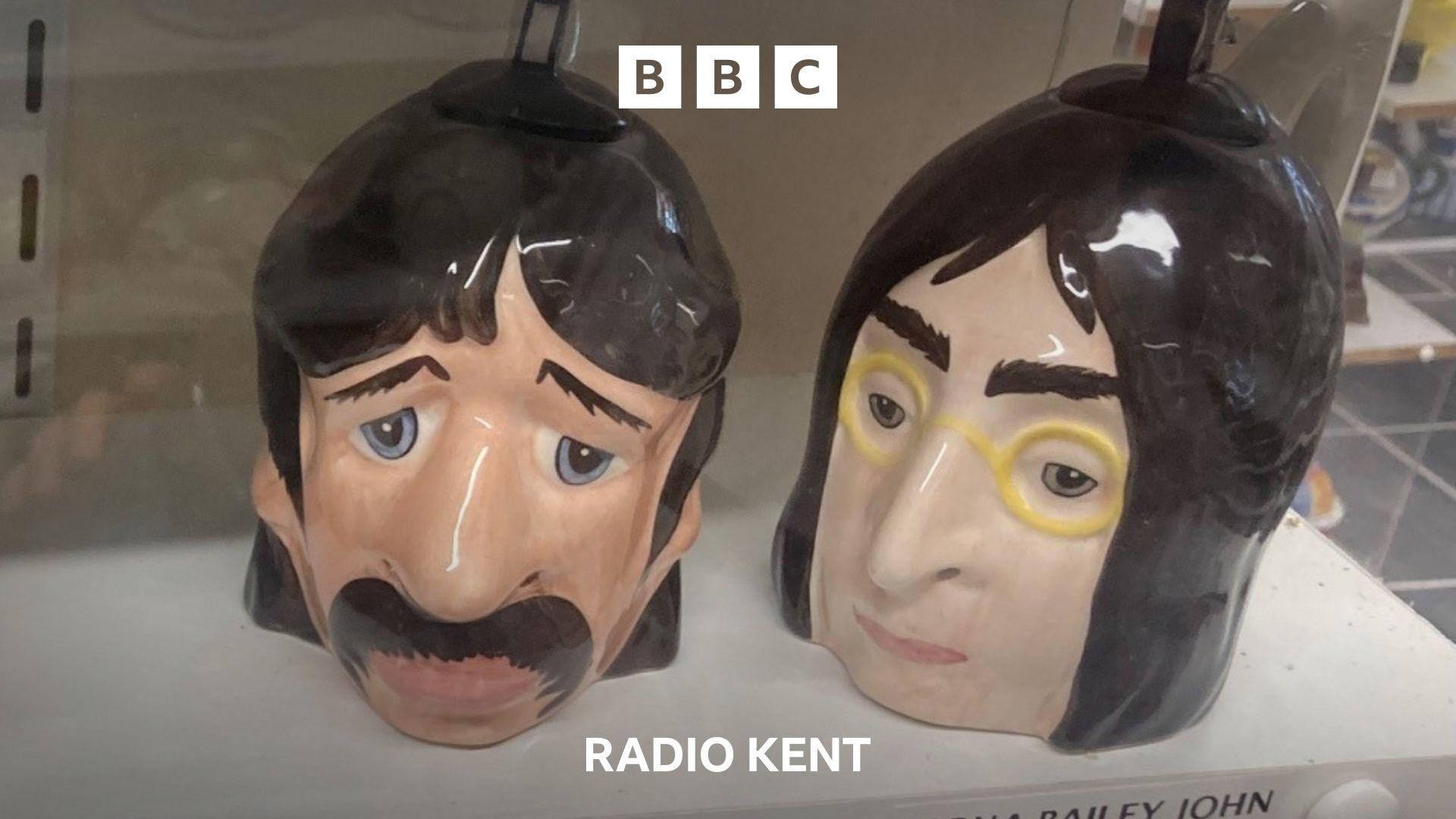 A pair of teapots resembling Ringo Starr and John Lennon.