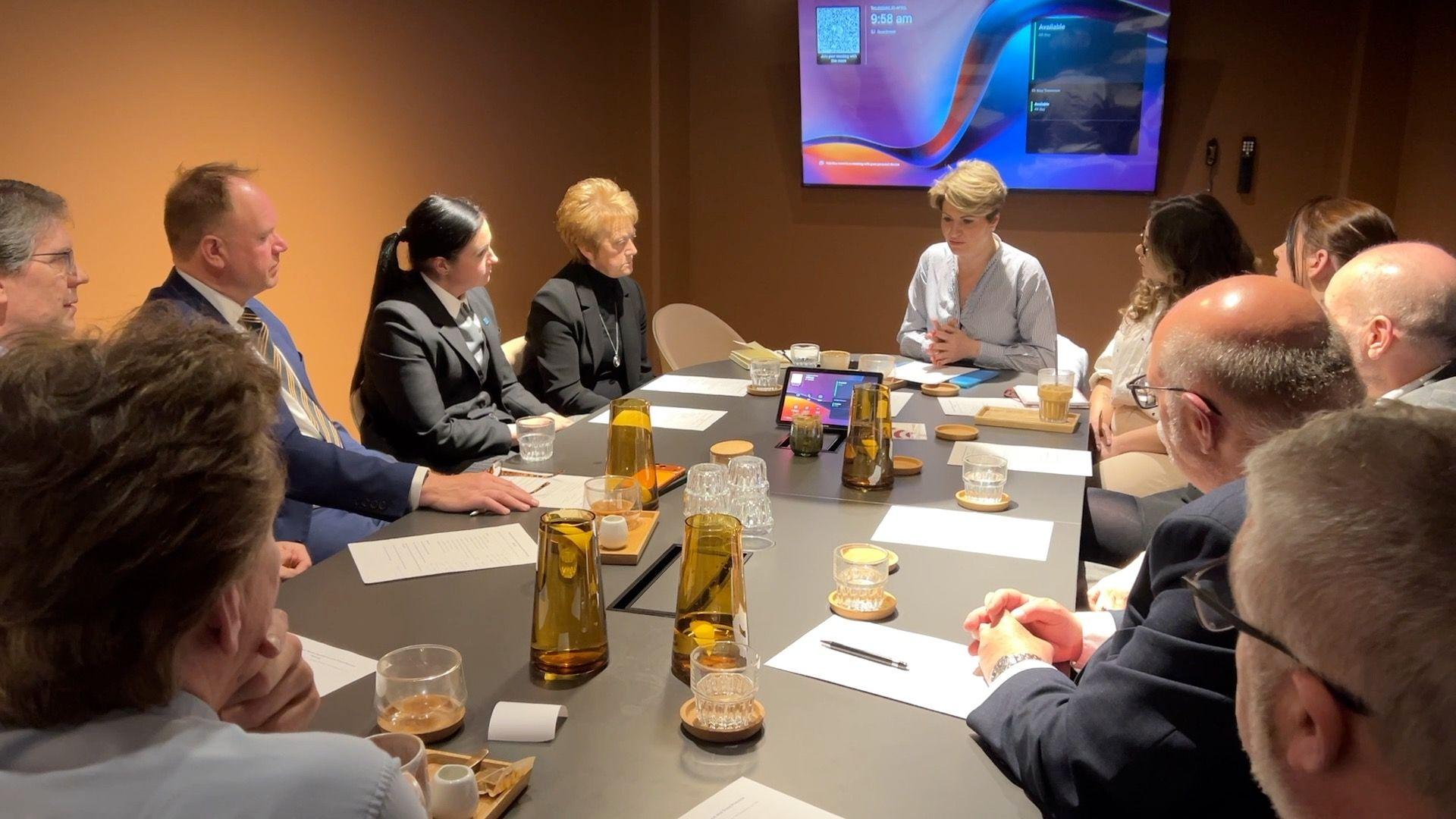 People sitting around a table at a meeting chaired by Emma Hardy MP