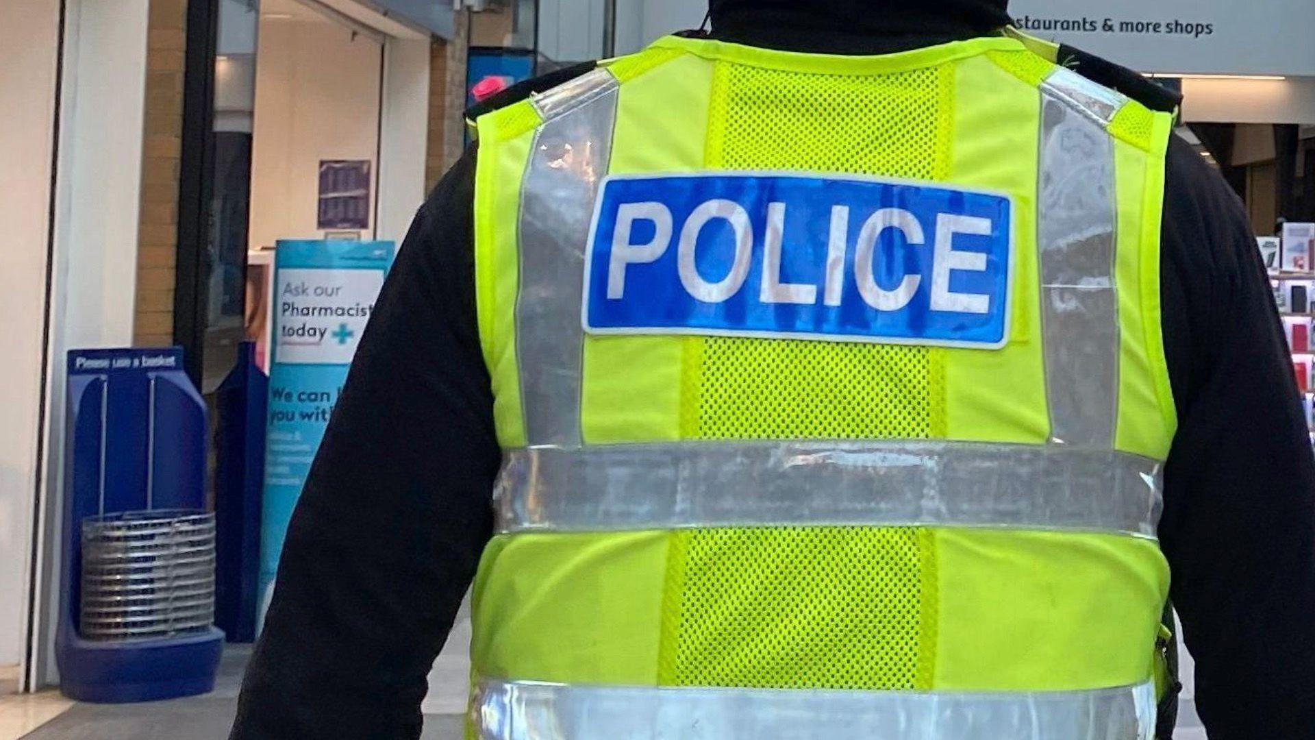 Close up of a policeman's back.