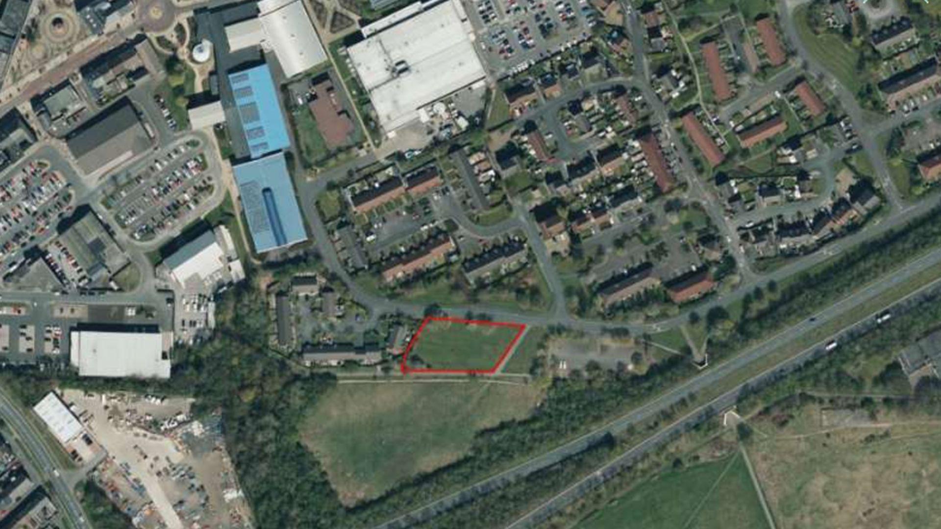 Looking down onto a parallelogram-shaped patch of green land in Spennymoor. The patch has been identified for the development.