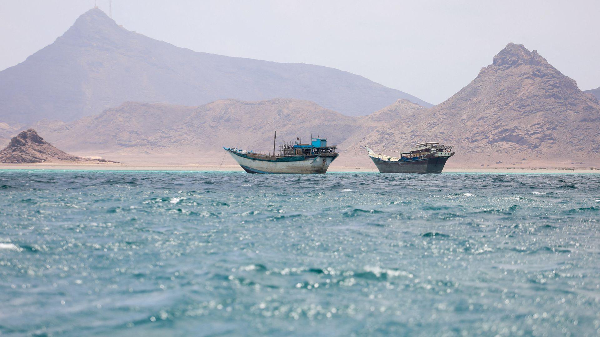 Boats float near the coast of Bab el-Mandeb, Yemen