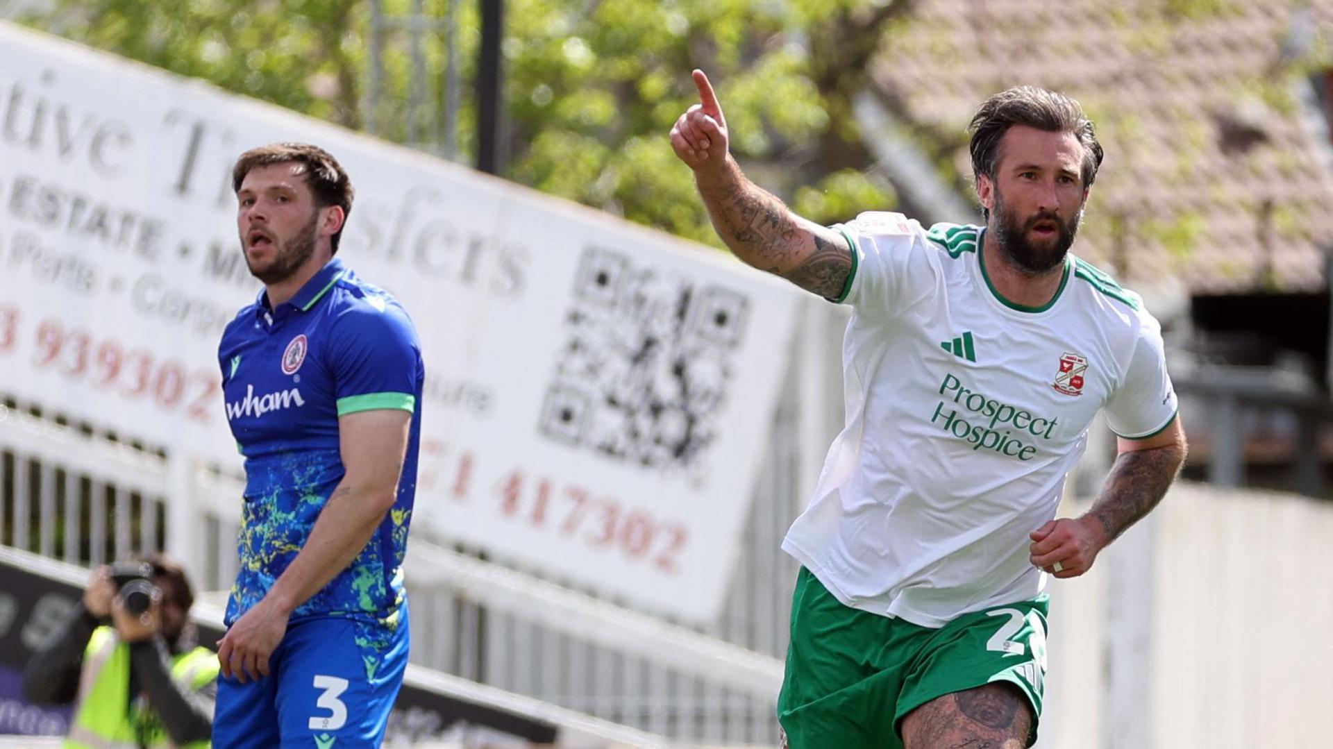 Ollie Palmer points upwards with his right index finger after scoring for Swindon Town against Accrington Stanley