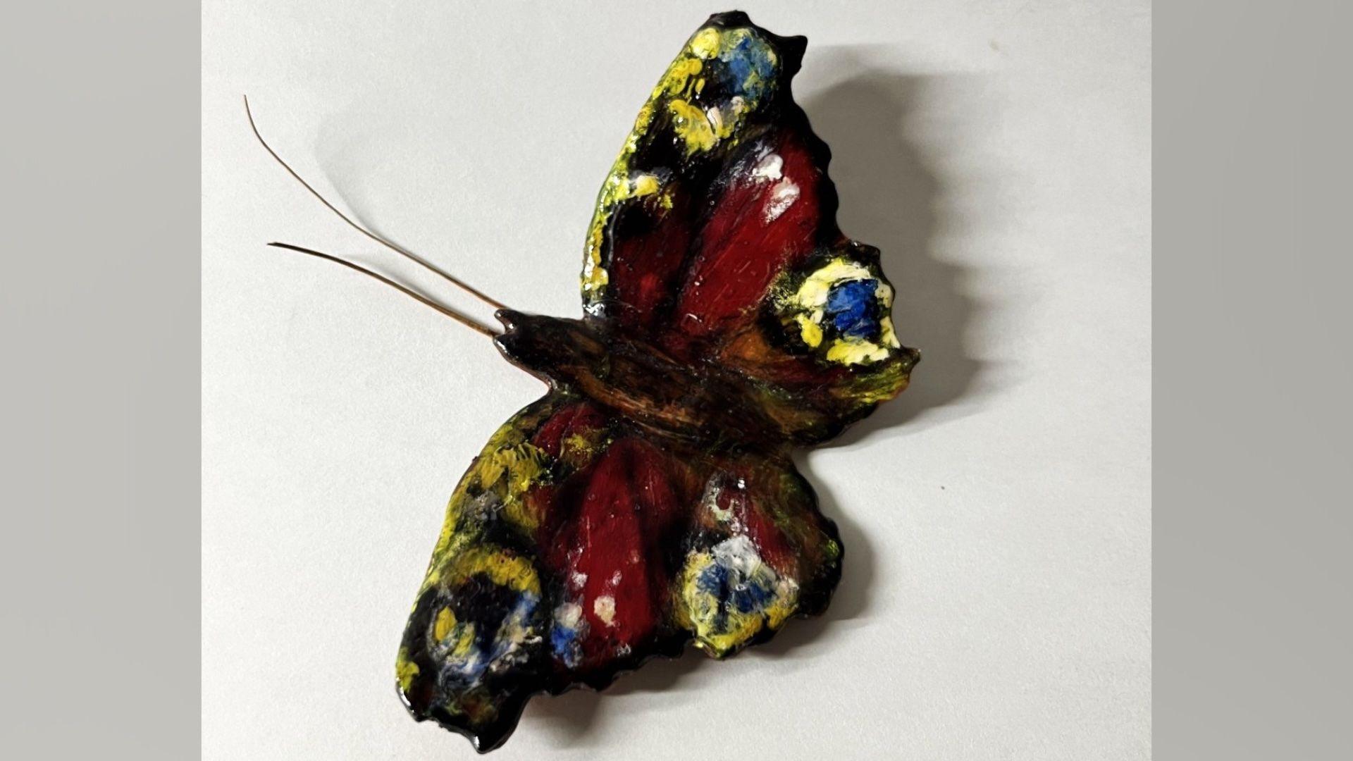 A 3D peacock butterfly model. It is yellow, red and blue. 