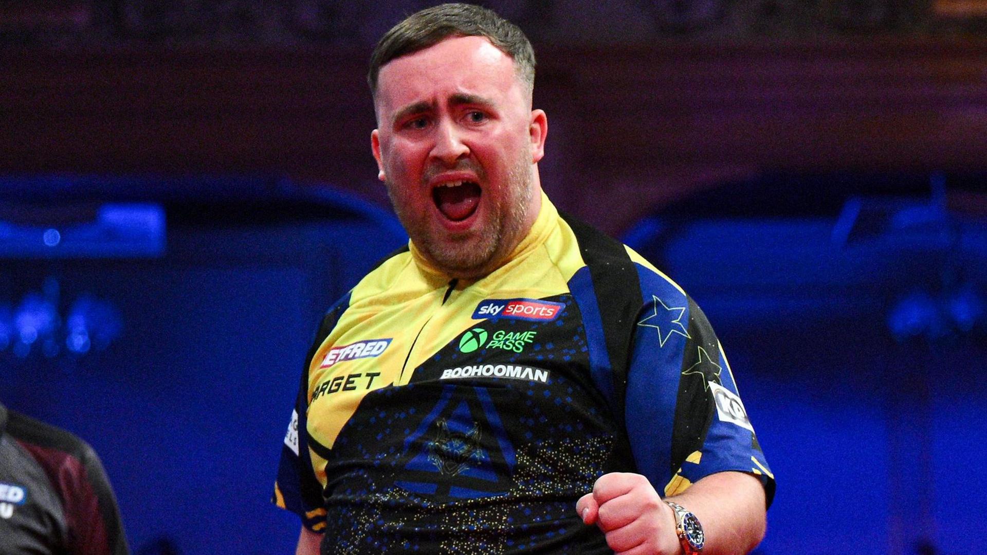 Luke Littler celebrates his nine-darter at the Winter Gardens in Blackpool