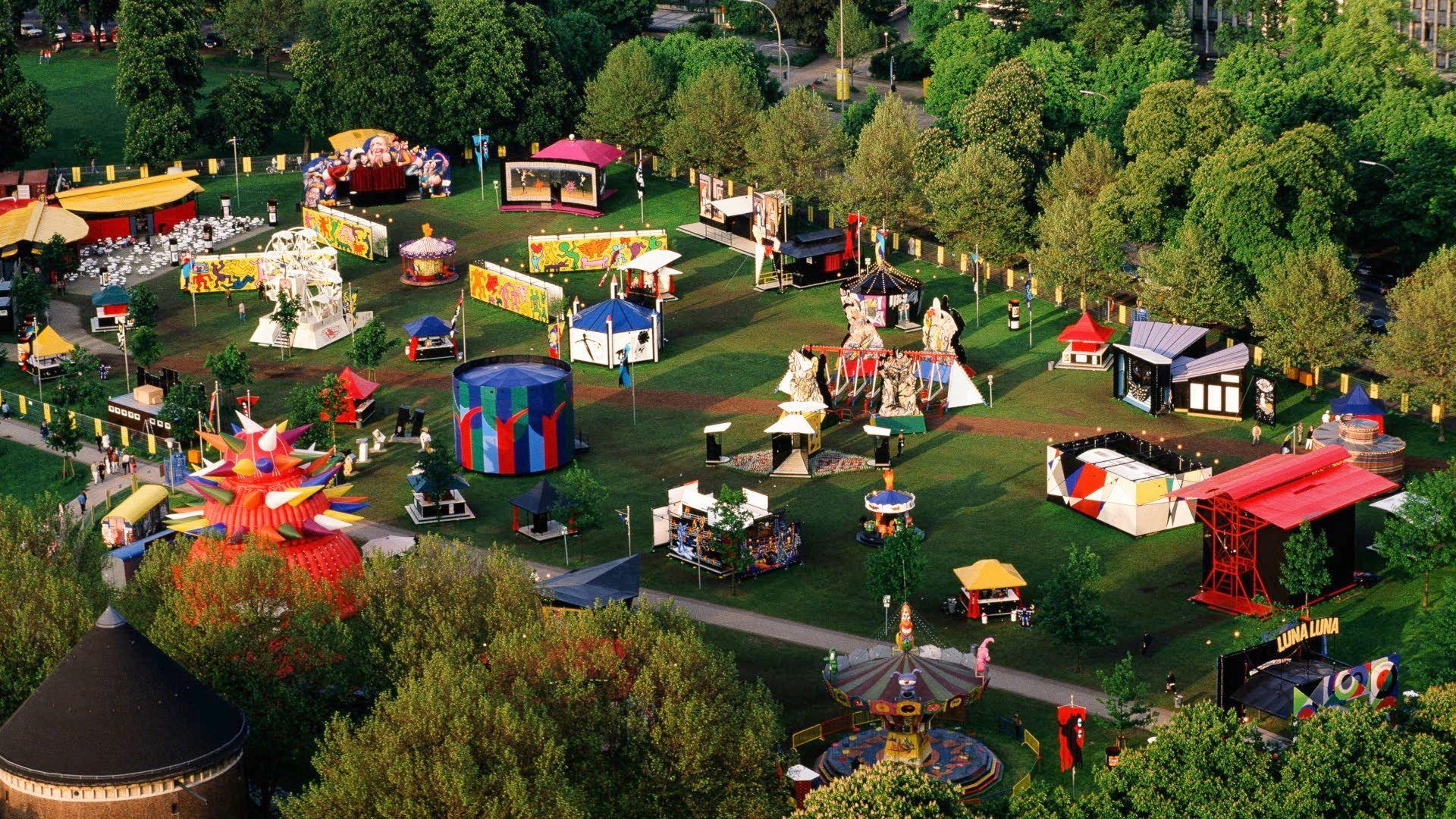 Luna Luna's rides and attractions from a birds eye view sit in a field.