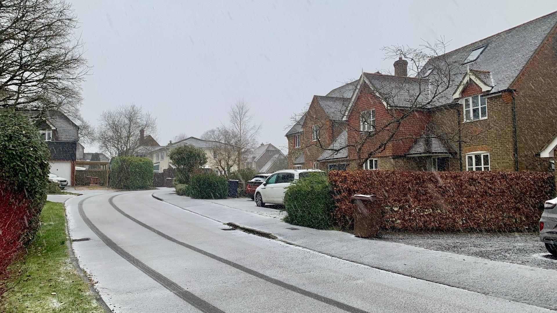 Light dusting of snow on a residential street