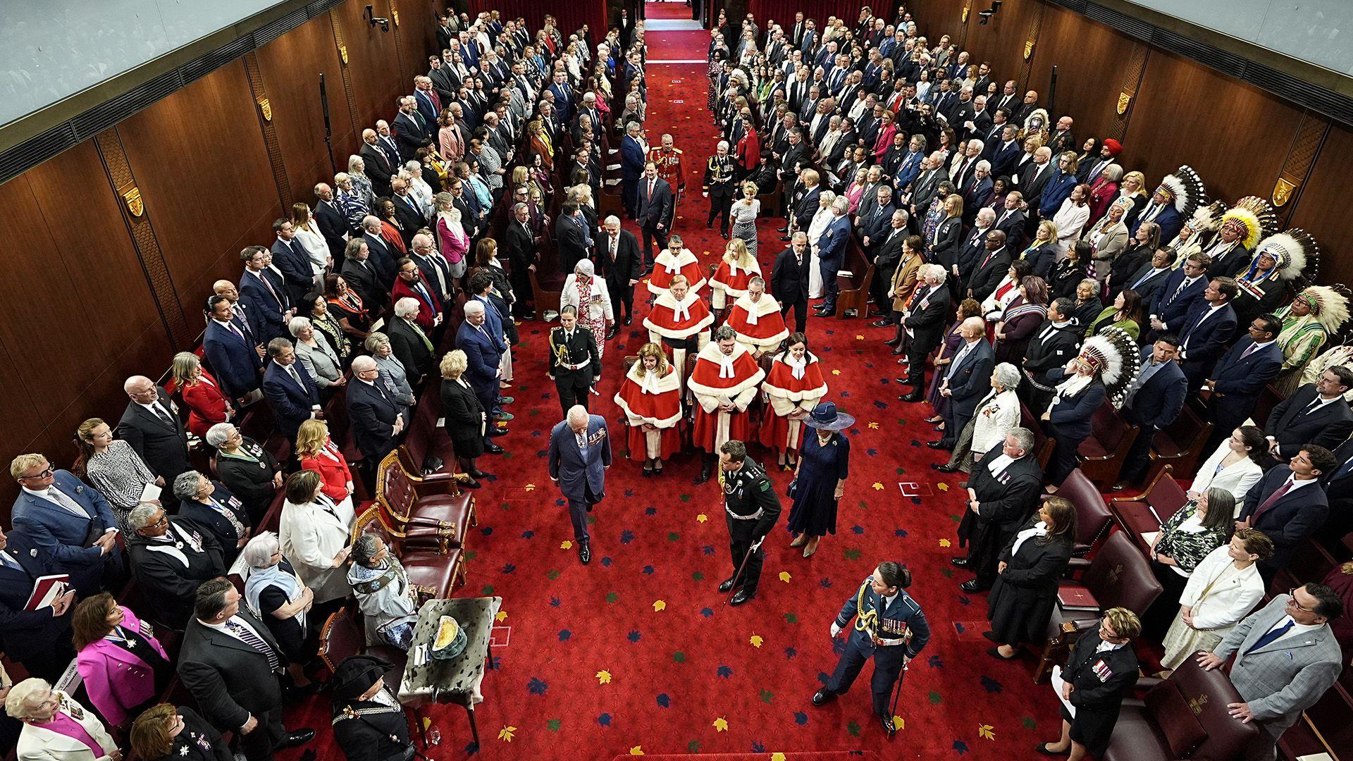 King Charles III and Queen Camilla are led in procession in the Senate Chamber at the Senate of Canada Building for the State Opening of the Parliament of Canada.