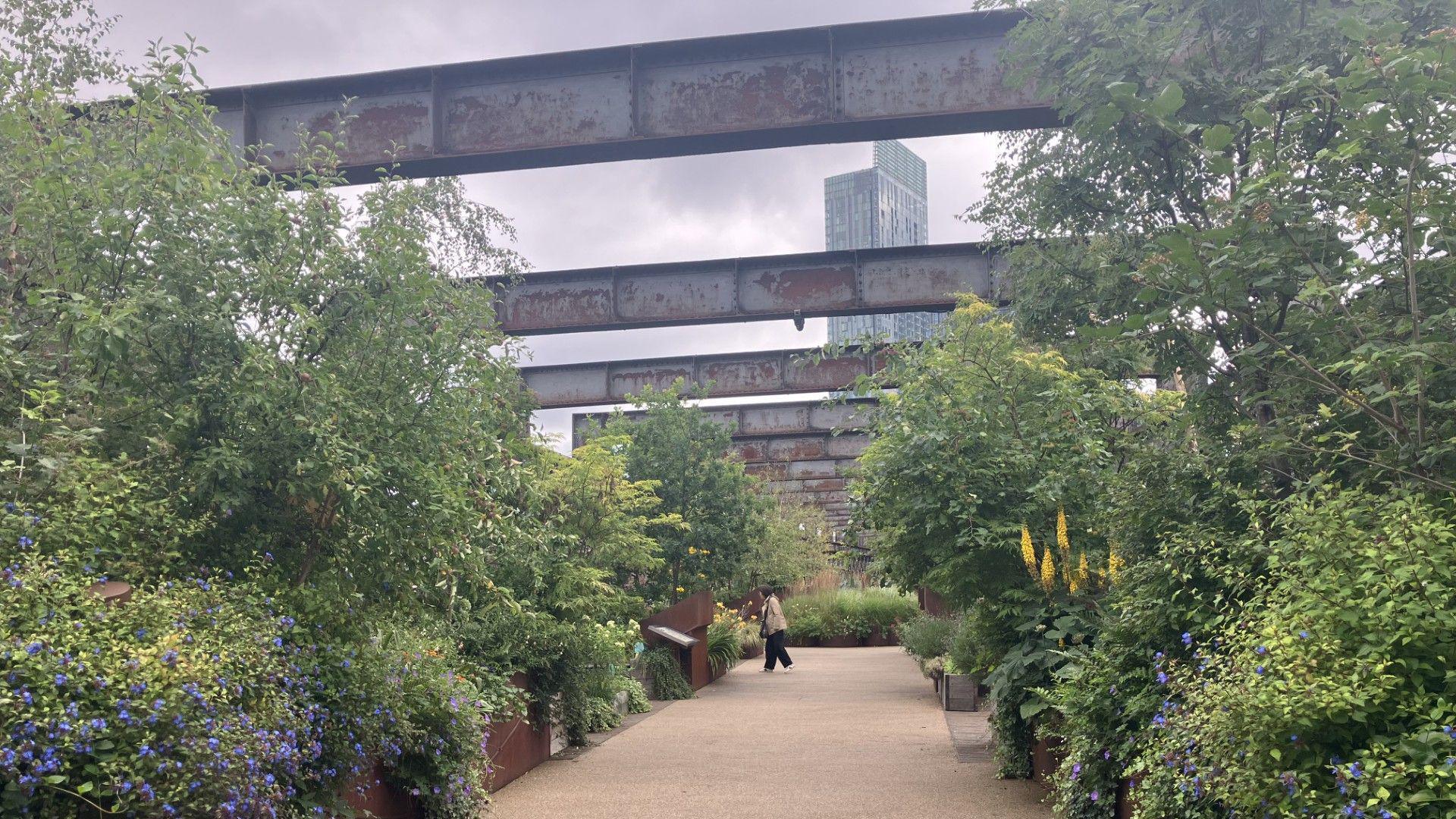 Flowers and plants line a section of Castlefield Viaduct in Manchester.