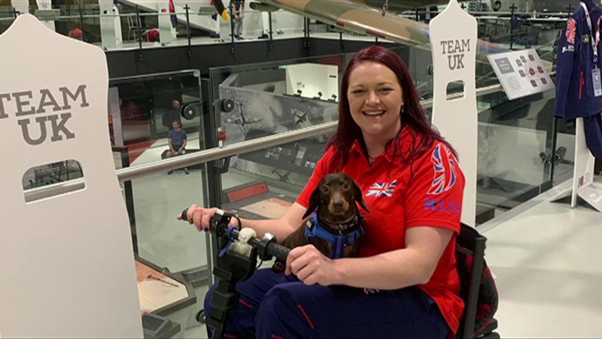 Martha Prinsloo sitting in a wheelchair with her dog Daisy on her lap