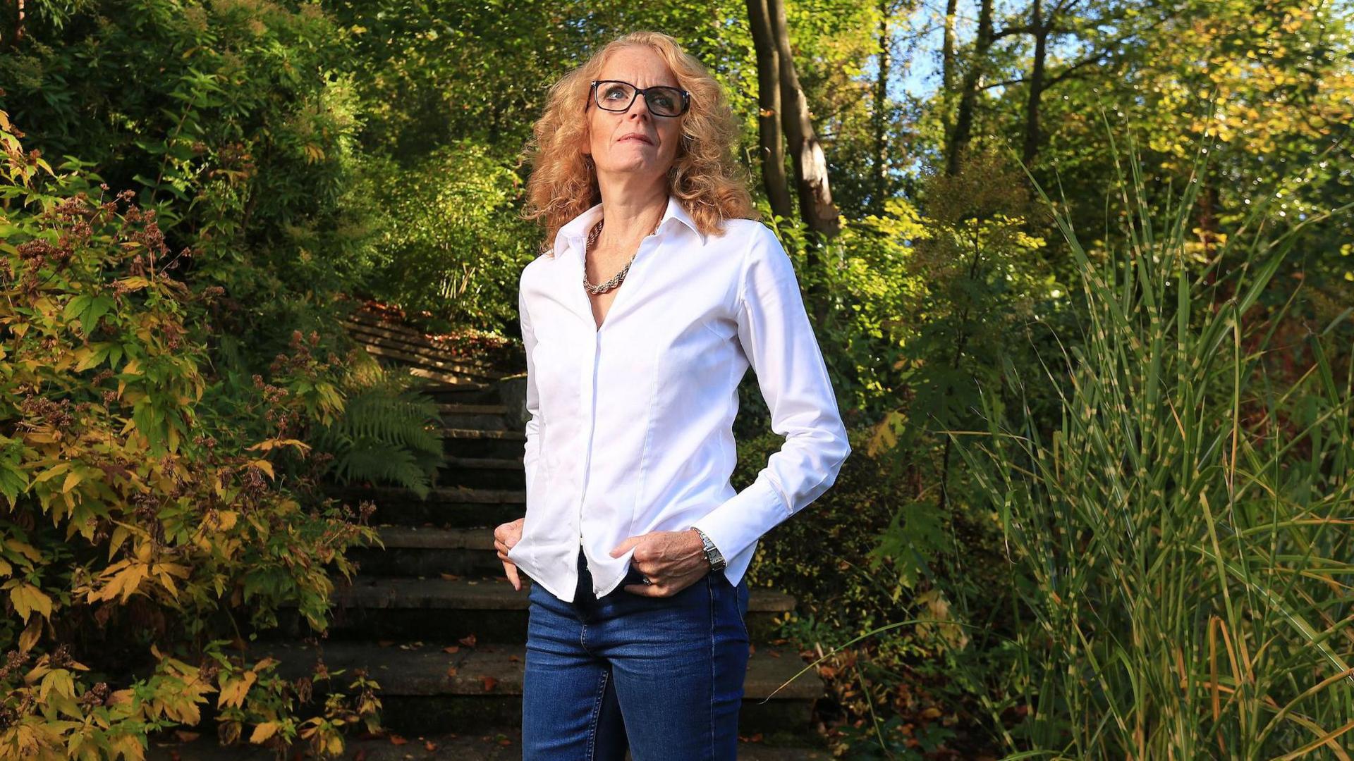 Dr Louise Jordan standing in her garden