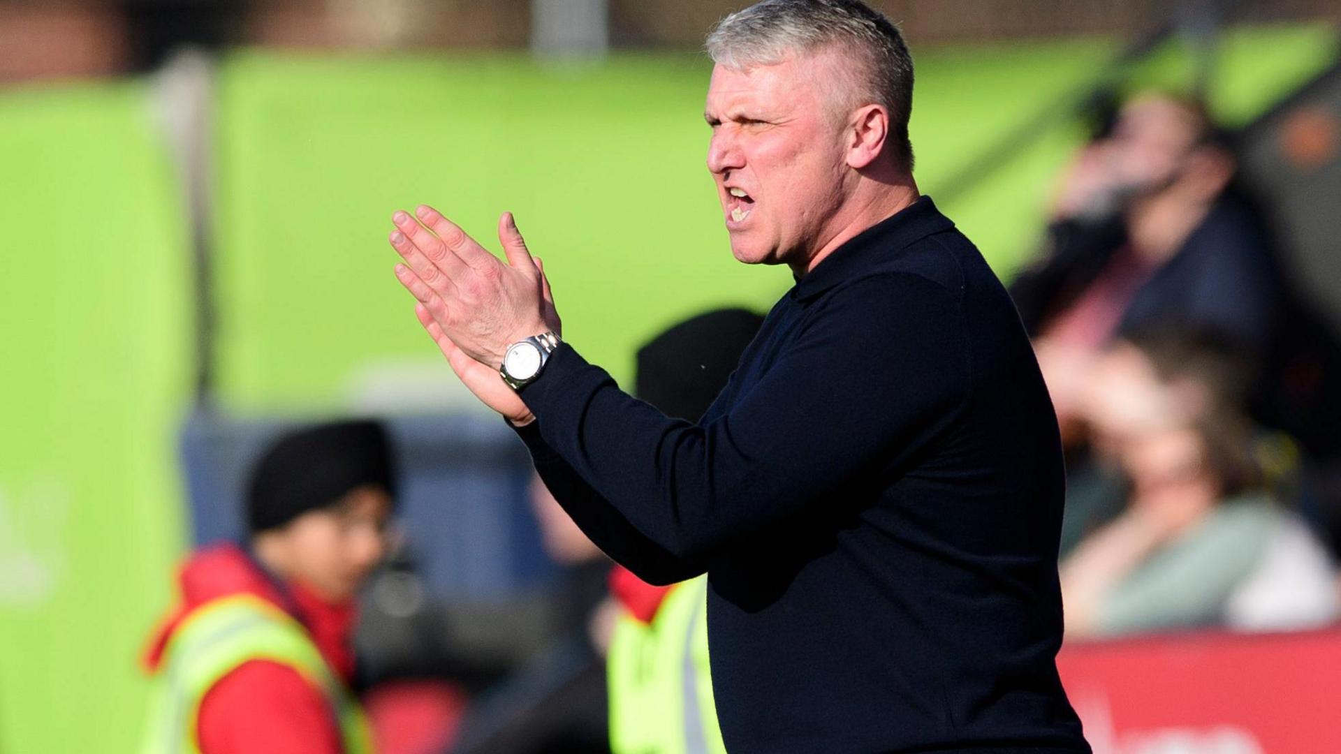 Rotherham United boss Lee Clark, wearing a dark jumper, shouts encouragement during his side's 3-0 defeat at Lincoln City in March