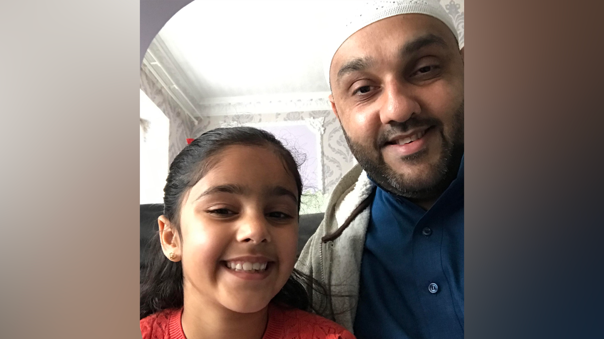 Imran Bahar and his daughter Zaira pose for a selfie. They are both smiling at the camera.