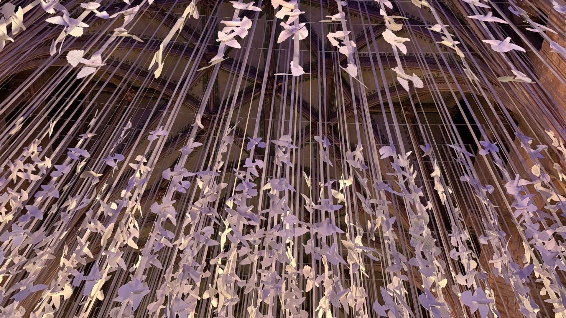 Hundreds of paper doves dangling from the ceiling in Tewkesbury Abbey.