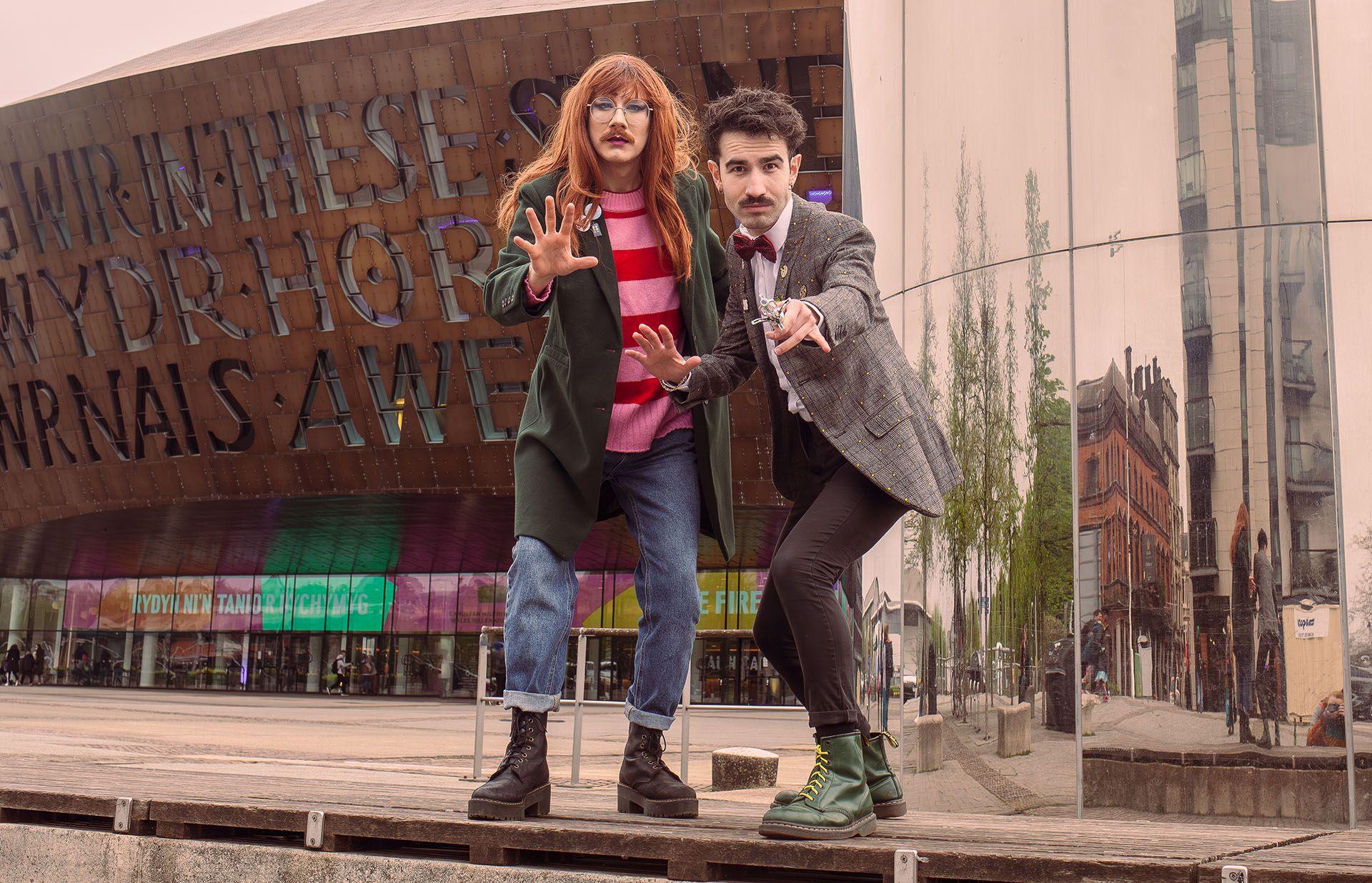 carrot and reece connolly dressed as the 11th doctor and donna in front of cardiff's millennium stadium