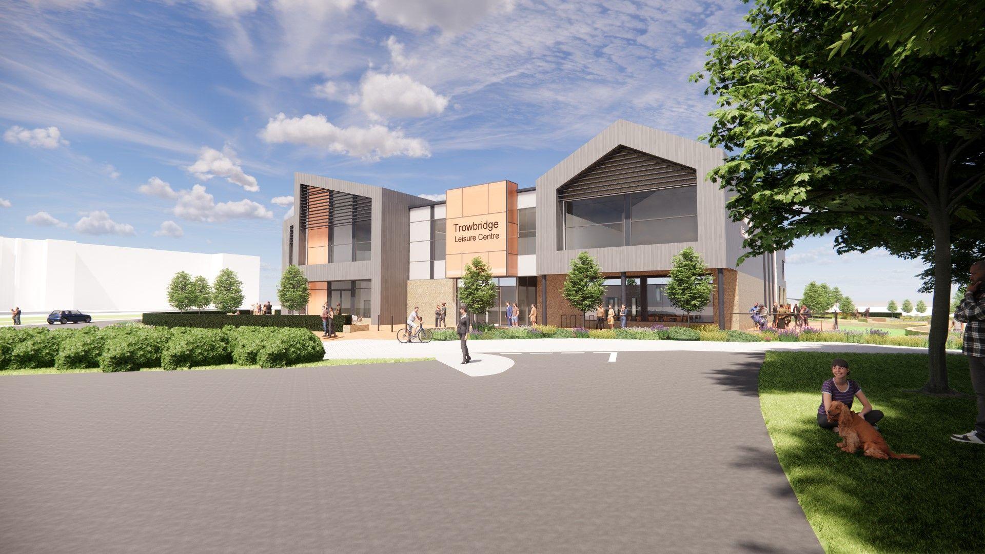 A computer generated image of what the leisure centre could look like taken from  low angle. It shows the front of the building, which has a Trowbridge Leisure Centre Sign. There are trees, bushes and grass surrounding the building and people are walking around it. In the foreground, on the right of the image, a person sits on the grass with a dog.