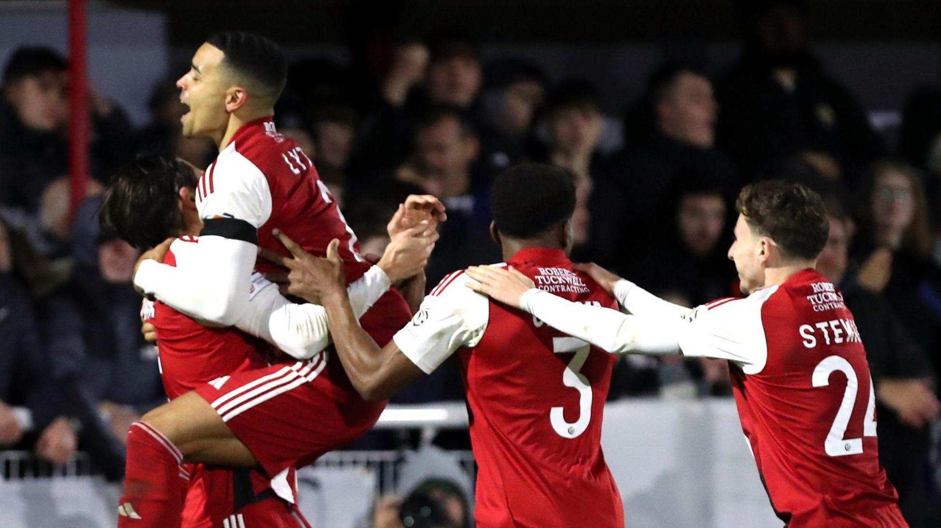 Brackley players celebrate their penalty shootout win over Notts County