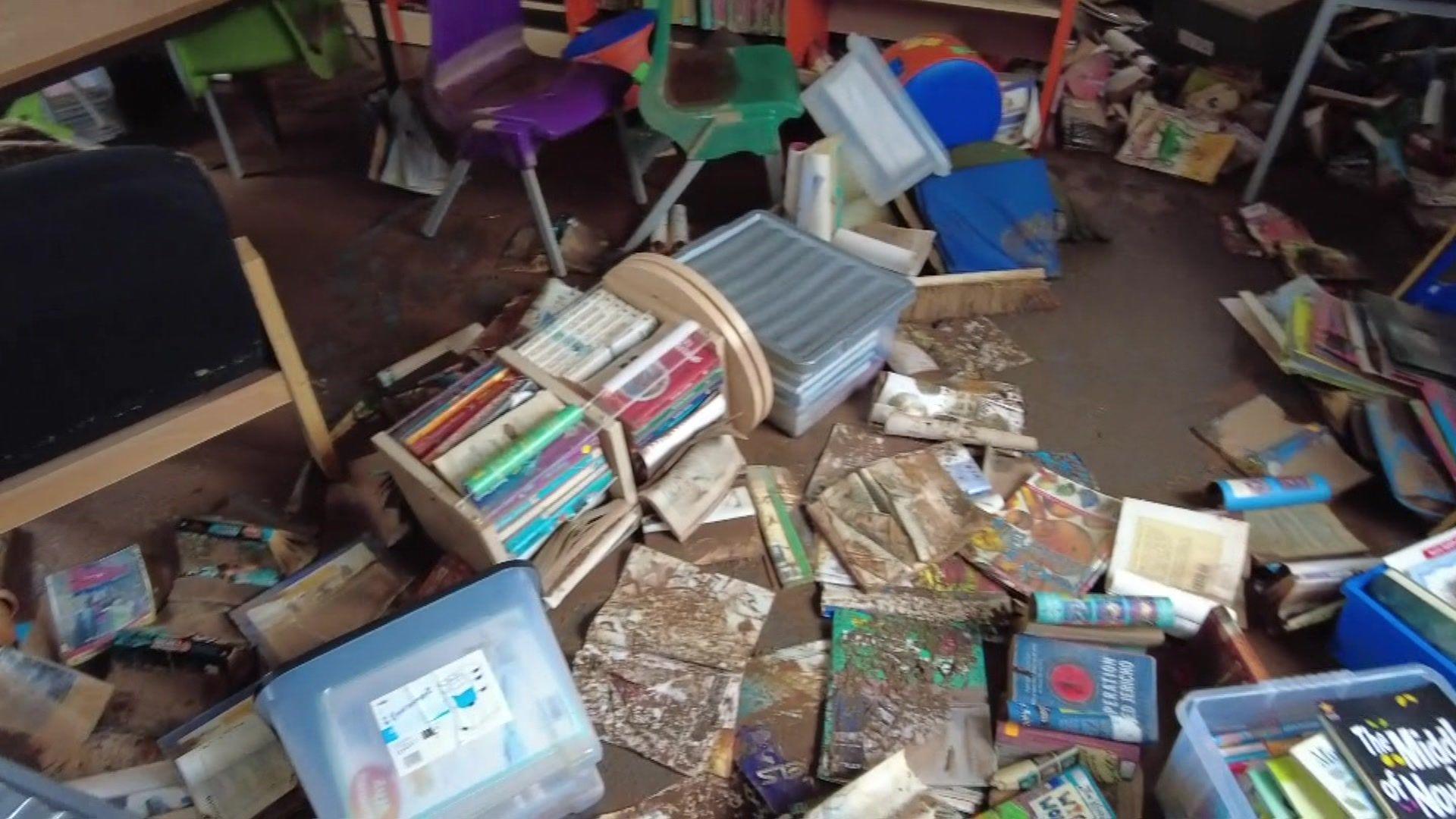 Books covered in mud on the floor