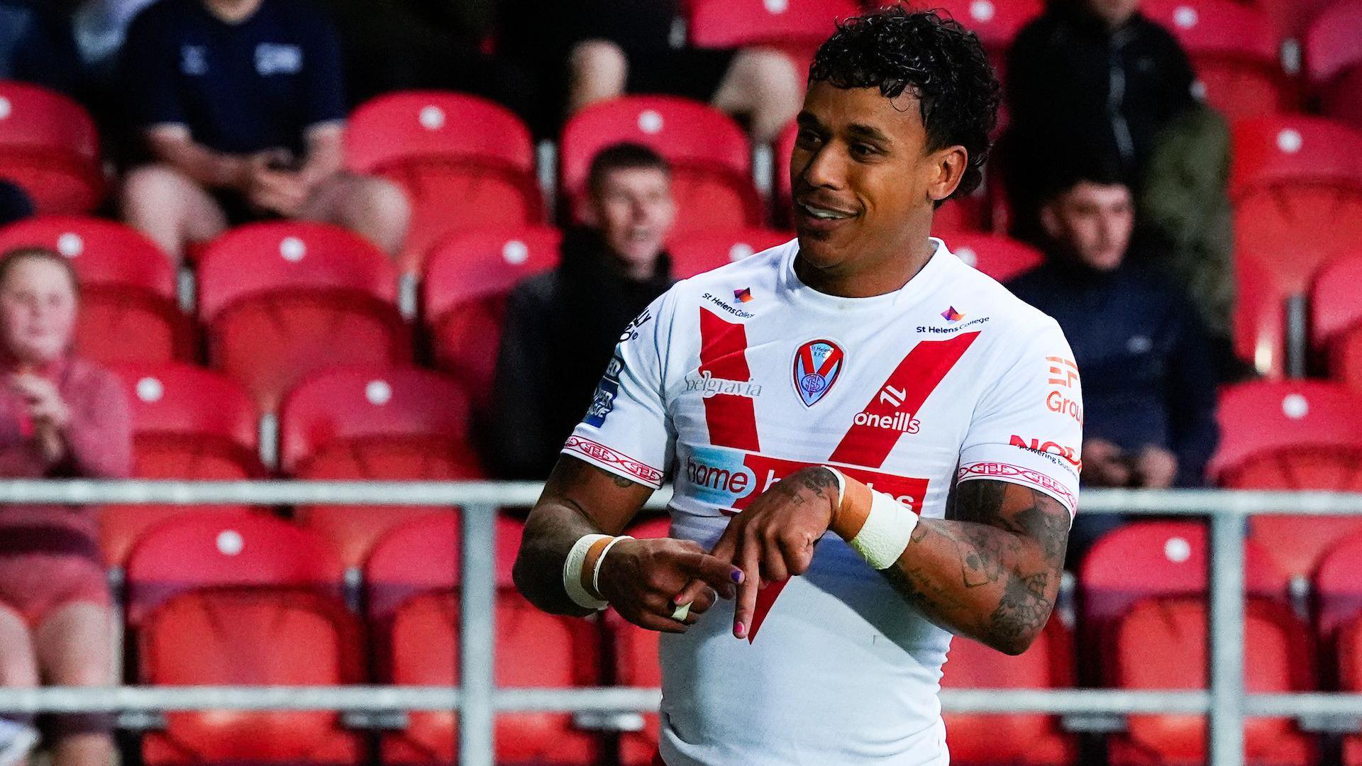 Tristan Sailor celebrates a St Helens try by making an A shape with his fingers.