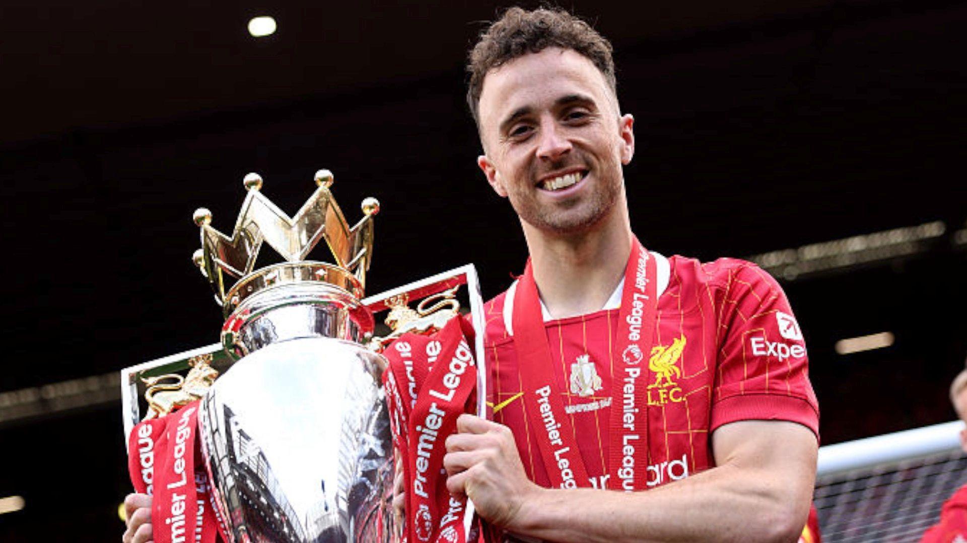 Diogo Jota of Liverpool poses for a photograph with the Premier League trophy