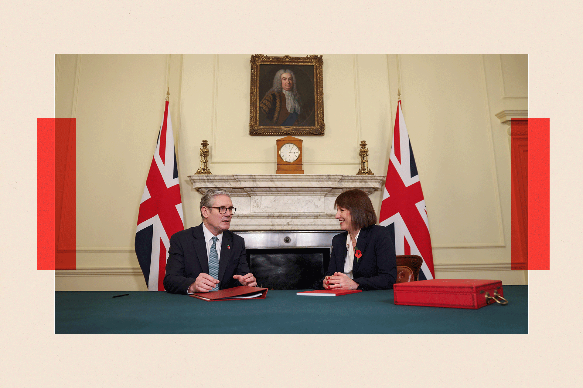 Keir Starmer meets with Rachel Reeves, they have a red folder in front of them with Union Jack flags behind
