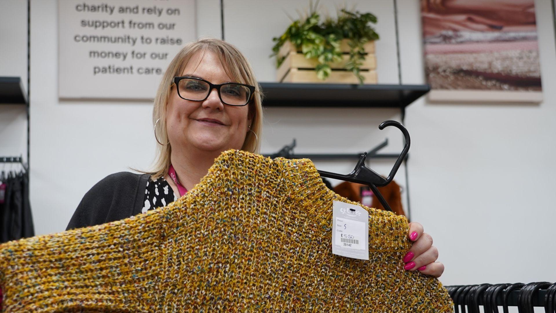 Emma Hawnt holding a yellow jumper