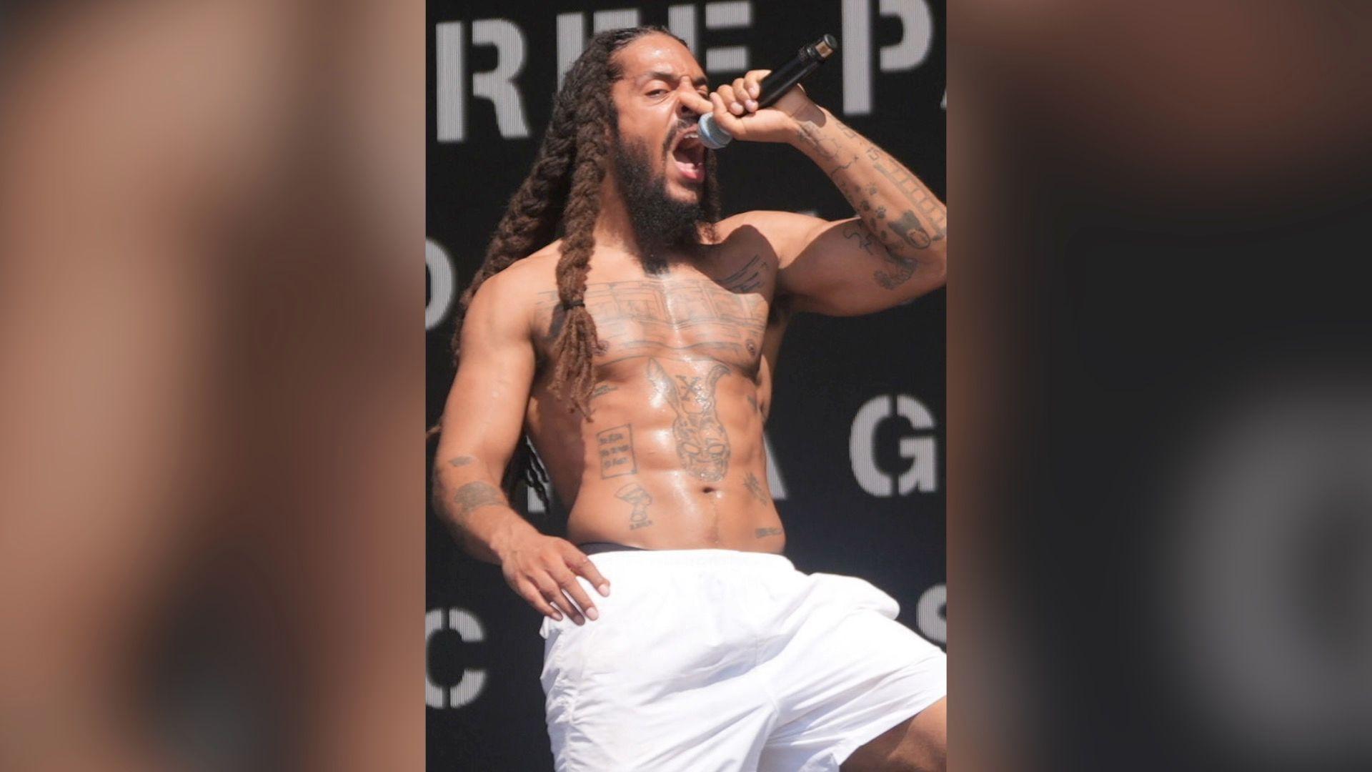Bobby Vylan, wearing white shorts, holds a mic as he performs on stage on Saturday
