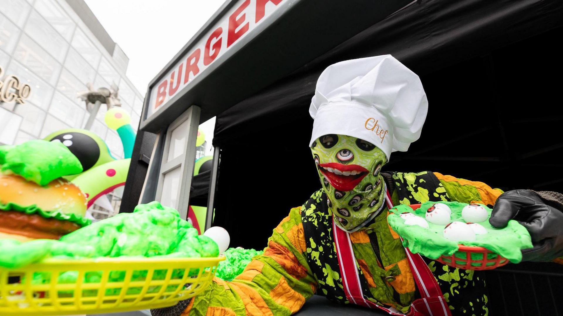 A green zombie serves ghoulish fare from a burger van