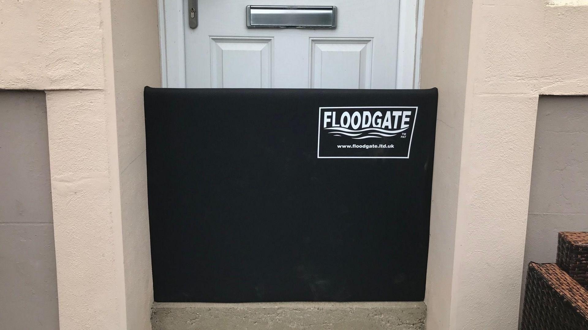 Flood gate fitted in front of a front door to prevent flooding