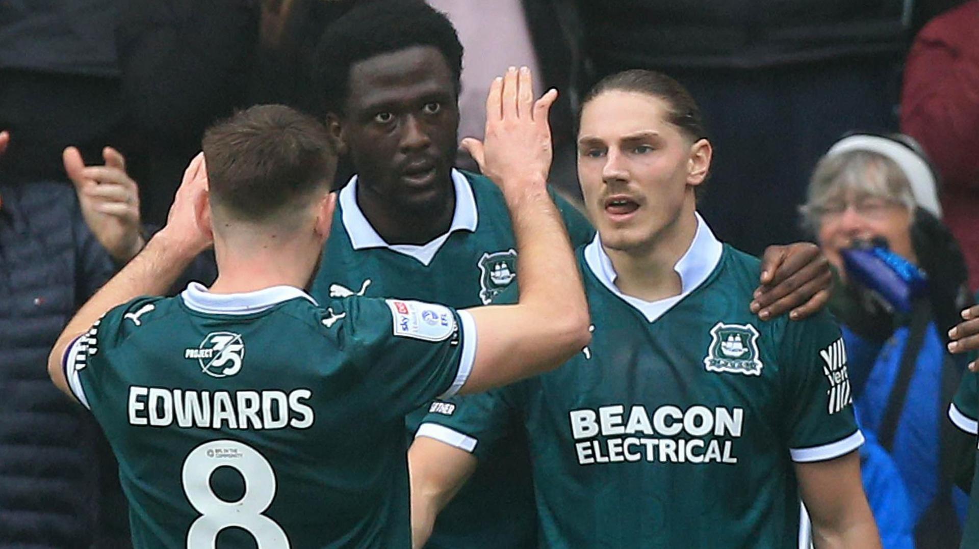 Lorent Tolaj celebrates with Plymouth midfielder Joe Edwards