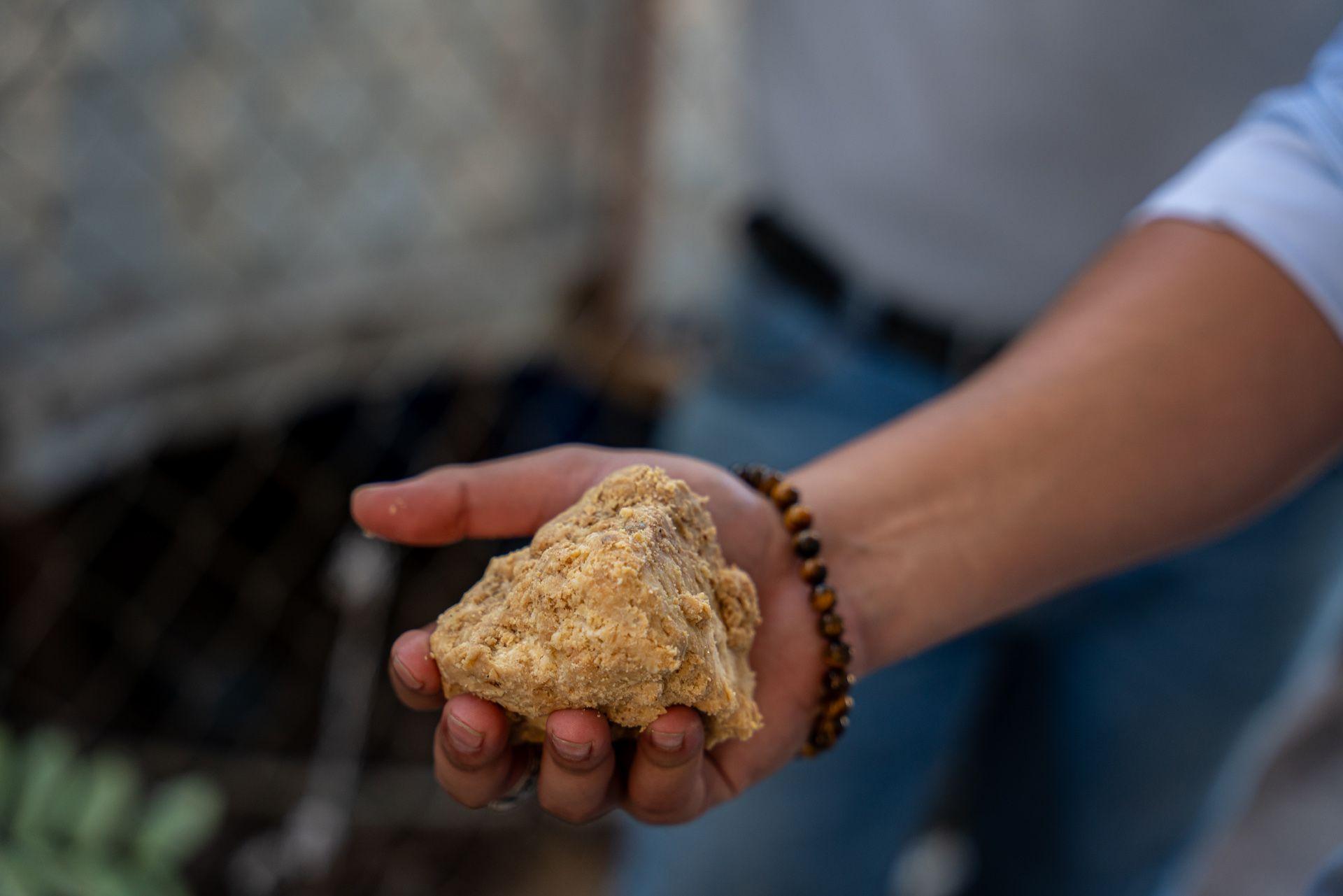 Ricardo Pineda holds up the raw soap substance