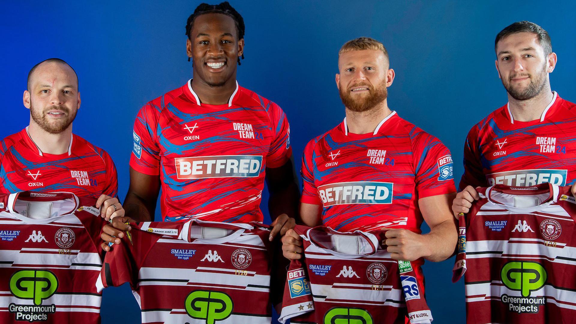 Liam Marshall, Junior Nsemba, Luke Thompson and Jake Wardle pose in their Dream Team kits with Wigan shirts