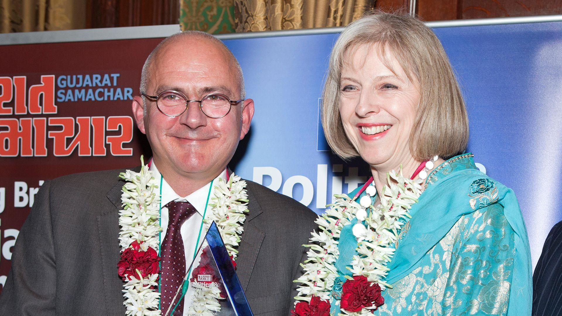 Andrew Norfolk, pictured with Theresa May in 2013, receiving the Reporter of the Year at the Political and Public Life Awards