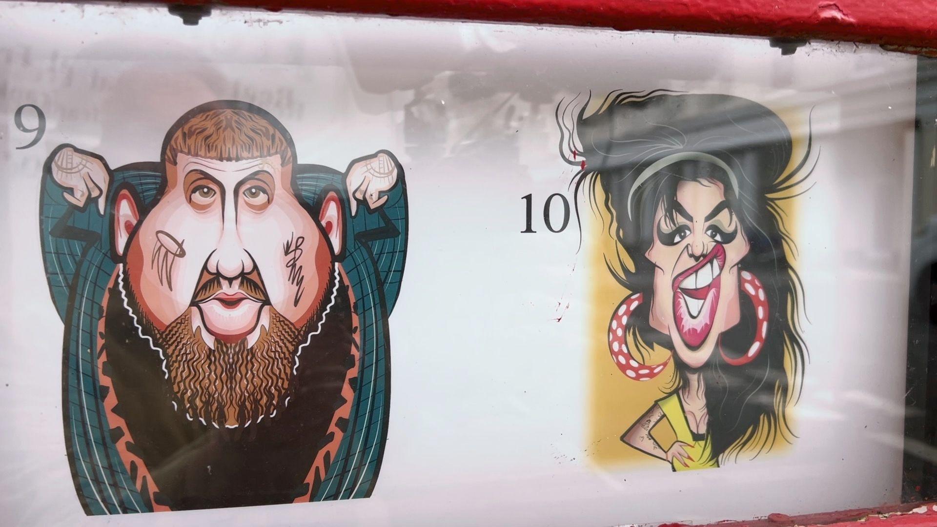 Caricatures of Rag'n'Bone Man and Amy Winehouse, displayed in the window of a telephone box